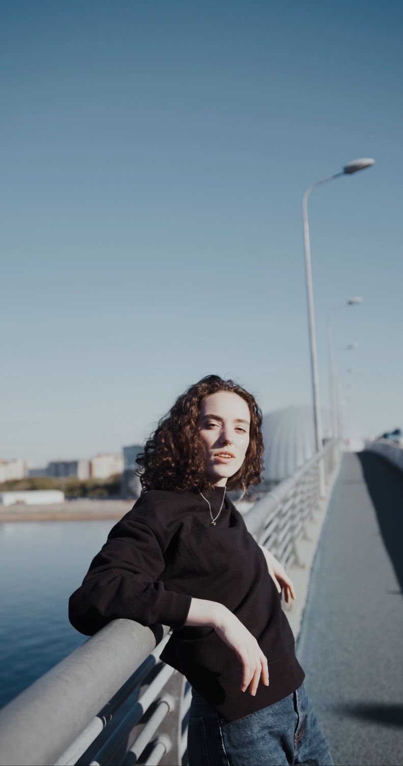 A woman standing on a bridge with her hand up Free Stock Video Footage ...