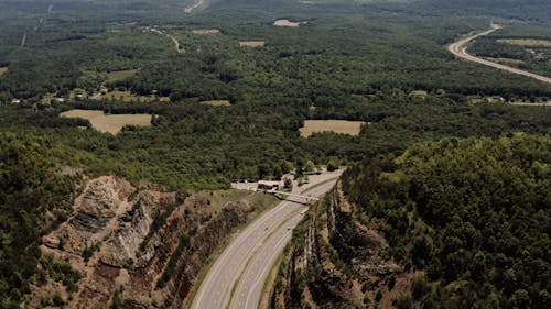 An Aerial Footage of a Landscape and a Highway