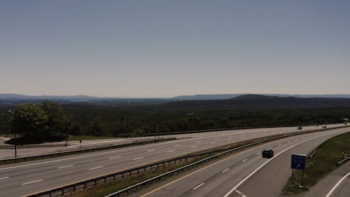 An Aerial Footage of a Landscape and the Highway