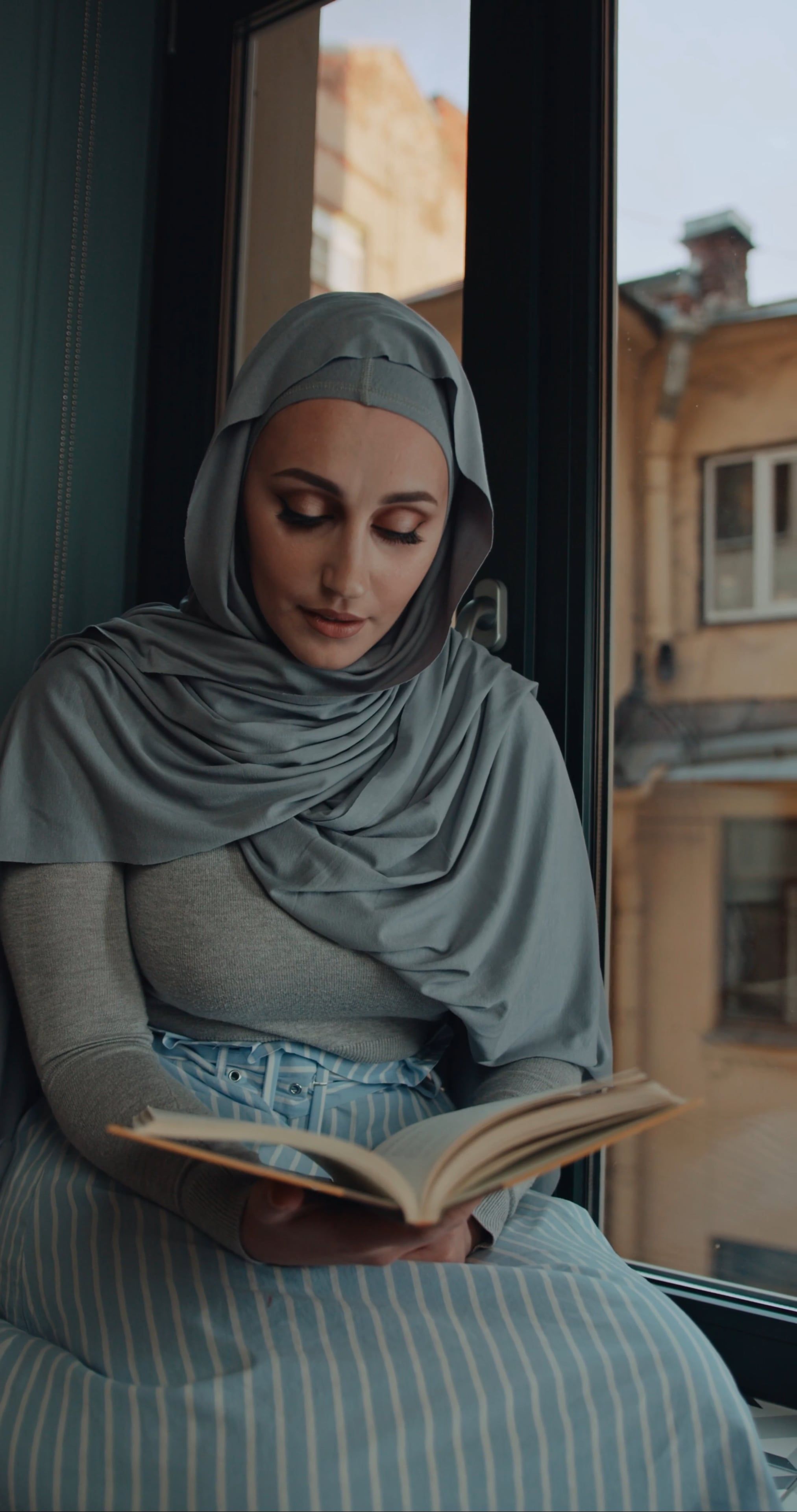 A woman in a hijab reading a book Free Stock Video Footage, Royalty ...