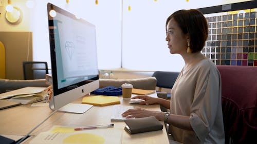 Woman Having A Conversation While Using Laptop In The Office 