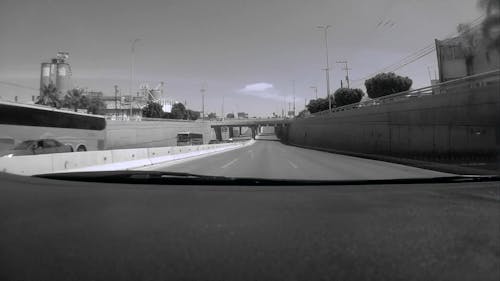 A Black and White Footage of Moving Cars on the Road