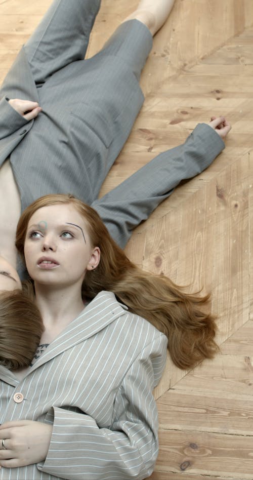 Two  Women Lying On The Floor On The Opposite Side