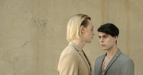 Two Young Men Posing while Looking at Each Other 