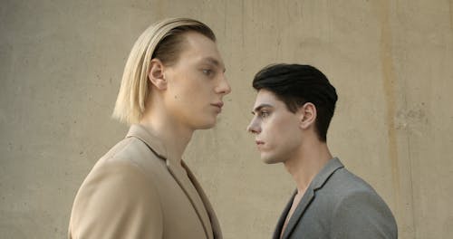 Young Male Models In Beige And Gray Coats