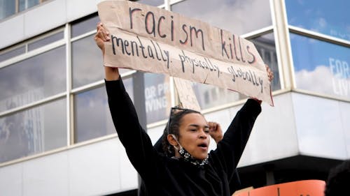 Woman Holding a Protest Sign on the Street