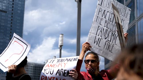 Woman Holding Up a Protest Placards