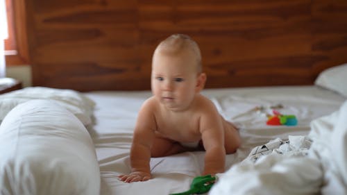 A Happy And Funny Baby On Bed