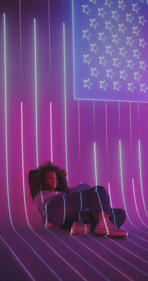 Woman in Front of a Projection of the American Flag