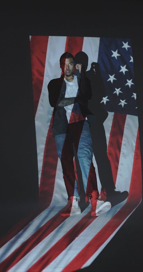 Man in Front of a Projection of the American Flag