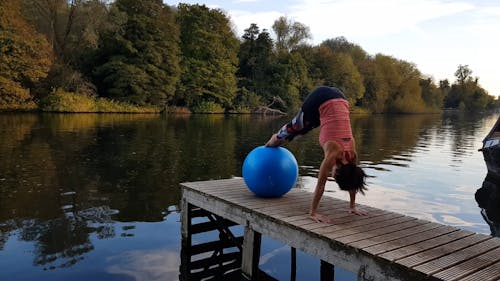 Woman Doing Stretching Exercise With A Yoga Ball