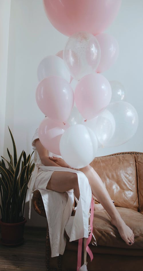 A Woman Peeking Through The Balloons
