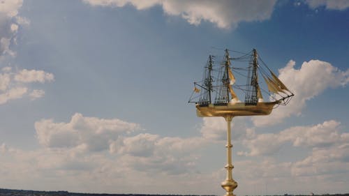 Arc Shot of a Golden Sculpture of a Sailing Ship