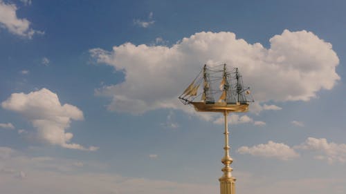 Arc Shot of a Golden Sculpture of a Sailing Ship