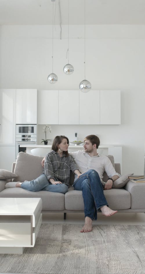 Couple Sweet Moments Together While Sitting on Sofa