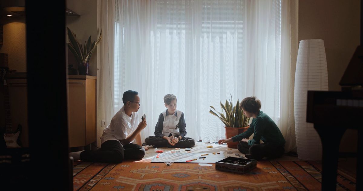 Family playing a board game together for kids board game night ideas