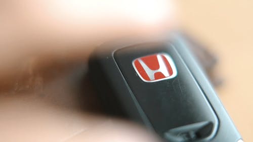 Close-up View Of Person Getting A Honda Brand Car Key