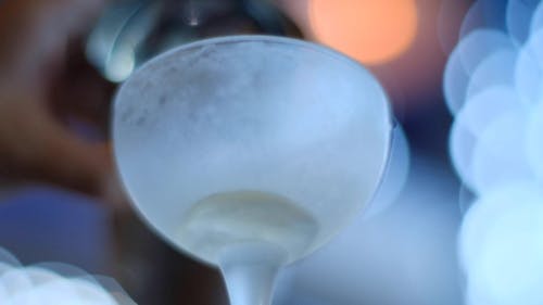 Close-Up View of a Milk Poured in a Wine Glass