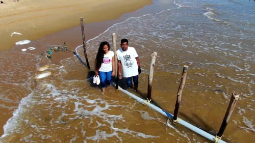 An Aerial Footage of a Man and a Woman on the Beach