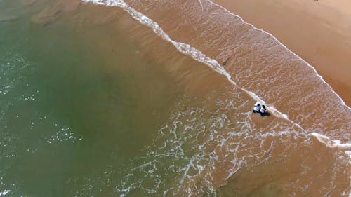 An Aerial Footage of a Couple on the Beach