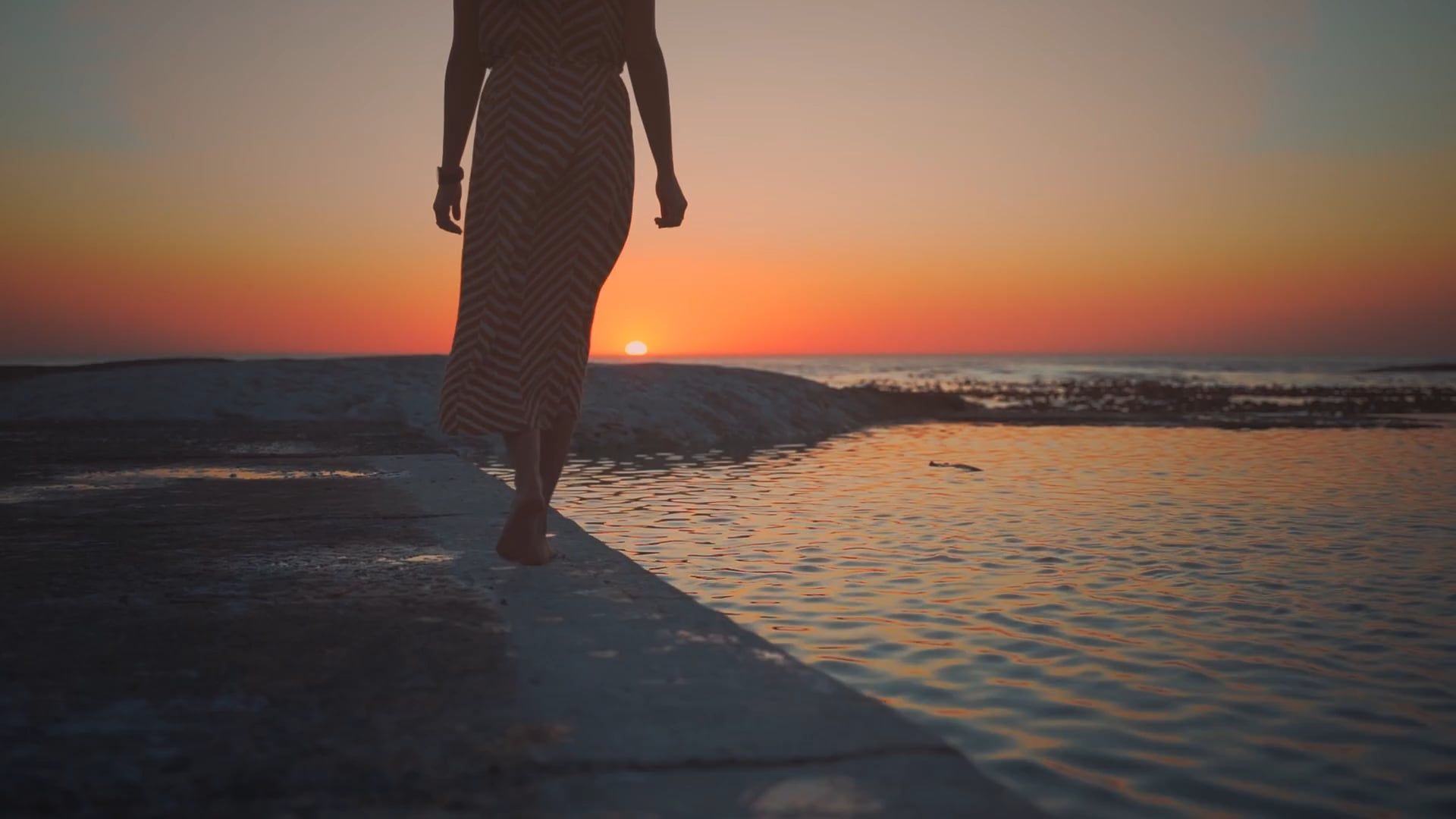 A Woman Walking at the Beach During Sunset · Free Stock Video