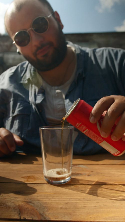 Man Pouring Soda into Glass
