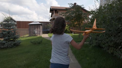 A Child Flying a Toy Plane