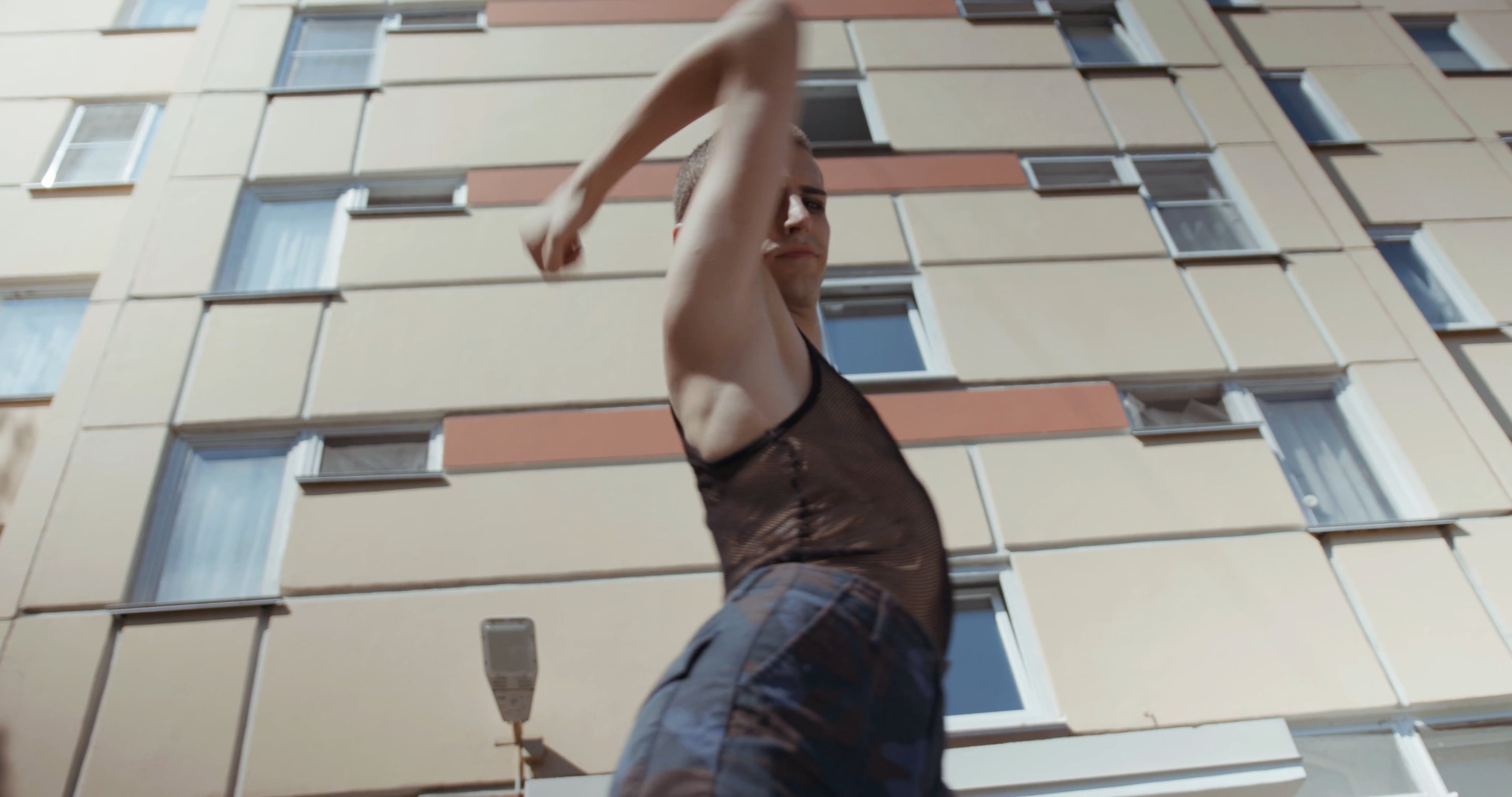 A woman is dancing in front of a building Free Stock Video Footage ...