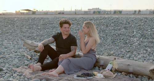 Man Proposing to His Woman in Rocky Beach Shore