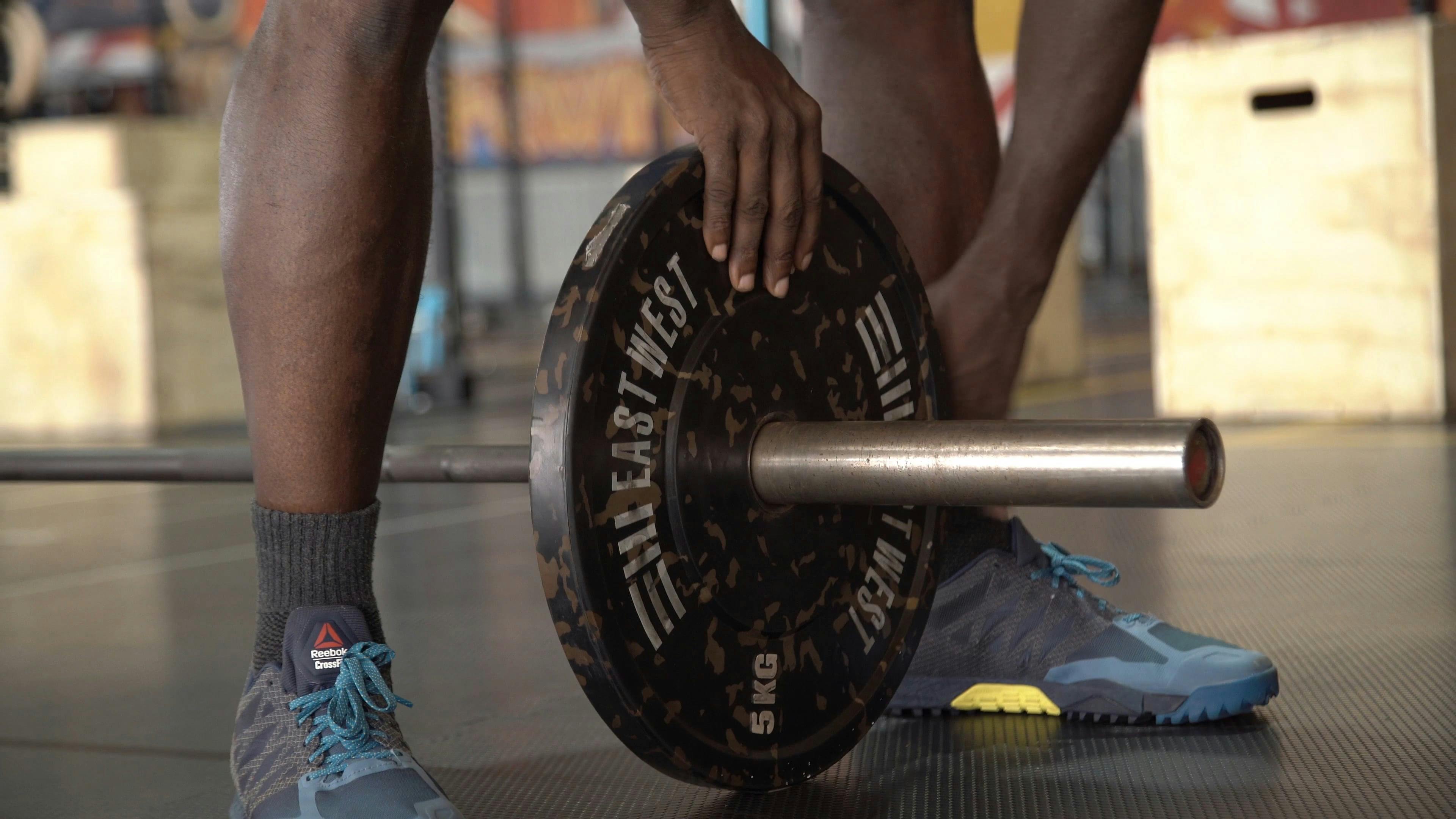 Putting Weights on a Barbell · Free Stock Video