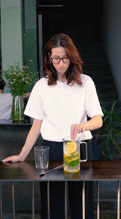 Video Of Woman Stirring A Pitcher Of Lemonade