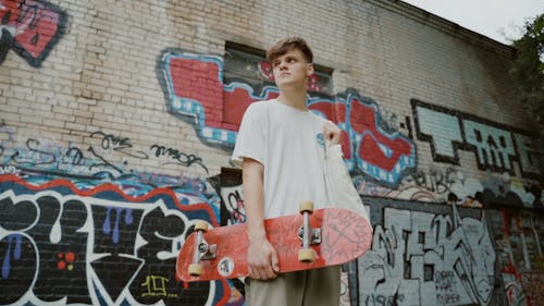 A Man Holding a Skateboard