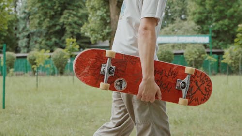 Young Man On The Road With A Skateboard 