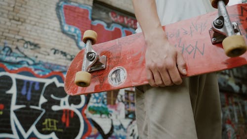 Young Man Holding a Skateboard