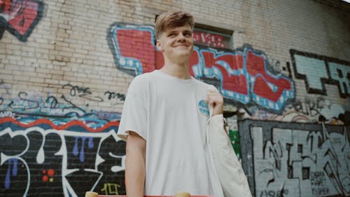 A Man Looking Around While Holding His Bag 