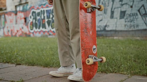 Young Man Holding a Skateboard