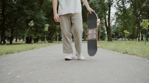 Young Man Ride a Skateboard at the Park