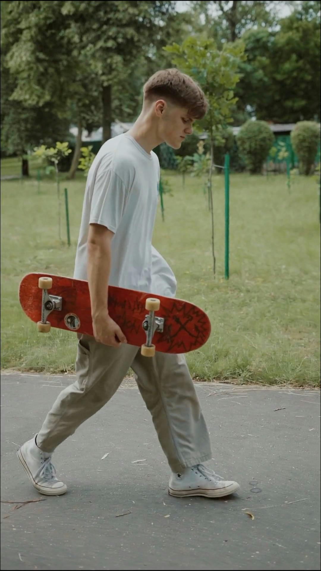 Young Man Walking With A Skateboard · Free Stock Video