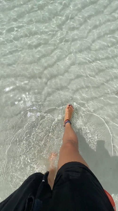 Woman Walking On White Sand Of Sea Water