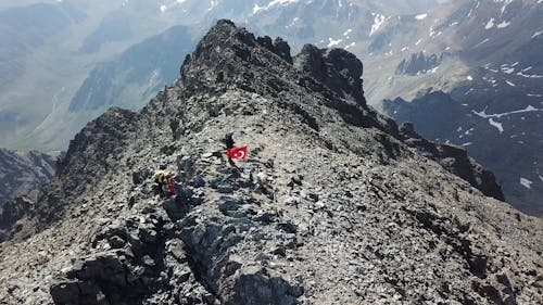 Climbers Standing On The Peak Of A Mountain