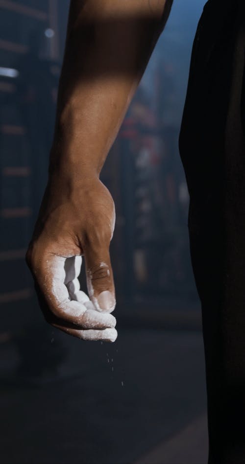 A Man's Hand Filled With White Talc Powder