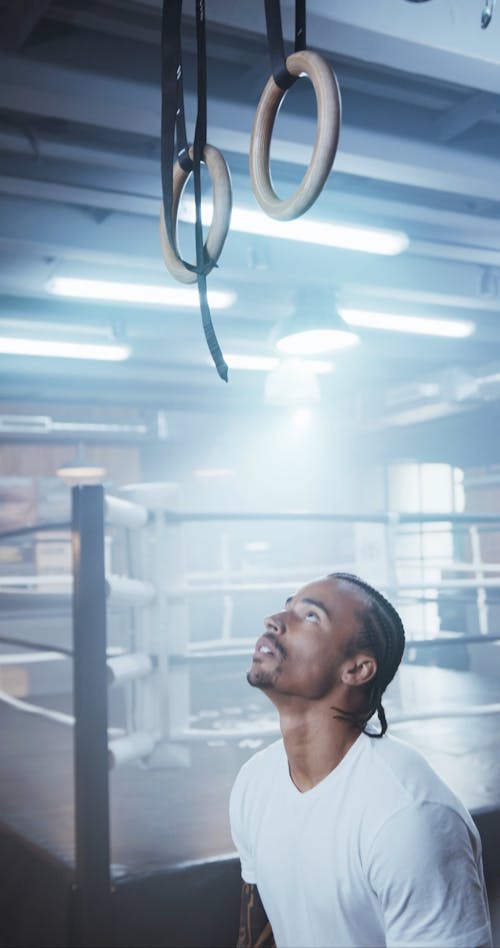 A Man Pull Up Exercise Using The Gymnastic Rings