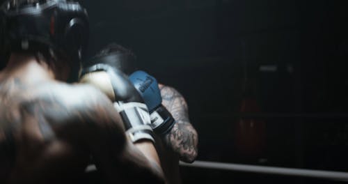 Two Men Sparring In A Boxing Match