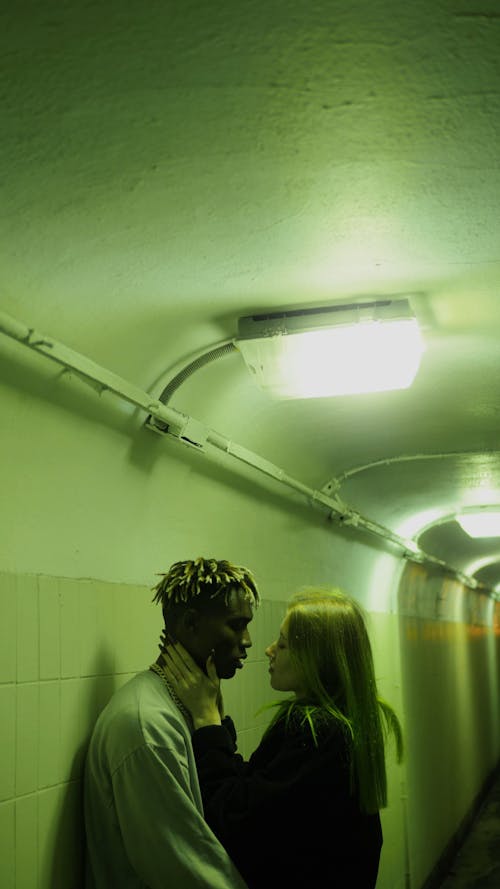 A Couple Cuddles In The Underpass Hallway