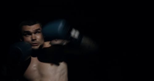 A Boxer Showing His Punching Skills In The Ring