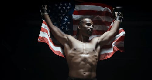 A Boxer Proudly Showing The American Flag In Victory
