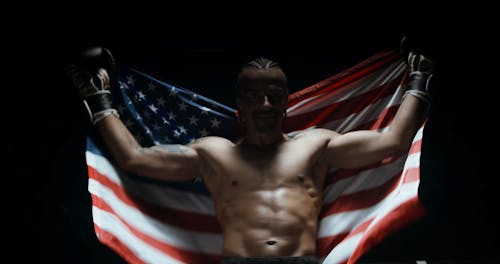 A Boxer Brandishing The American Flag In Victory