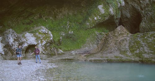 A Couple Throwing Skip Rock Over The Lake