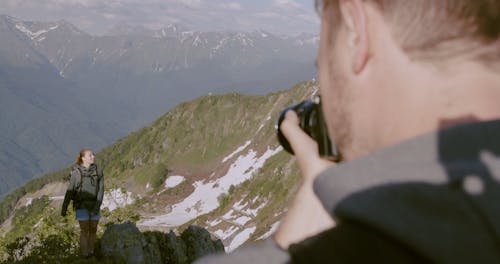 A Woman Having Her Photo Taken On The Mountain Top
