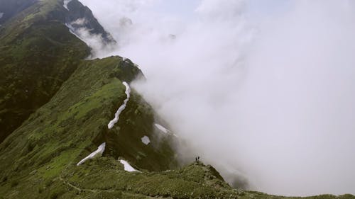 A Couple Standing On The Mountain Peak